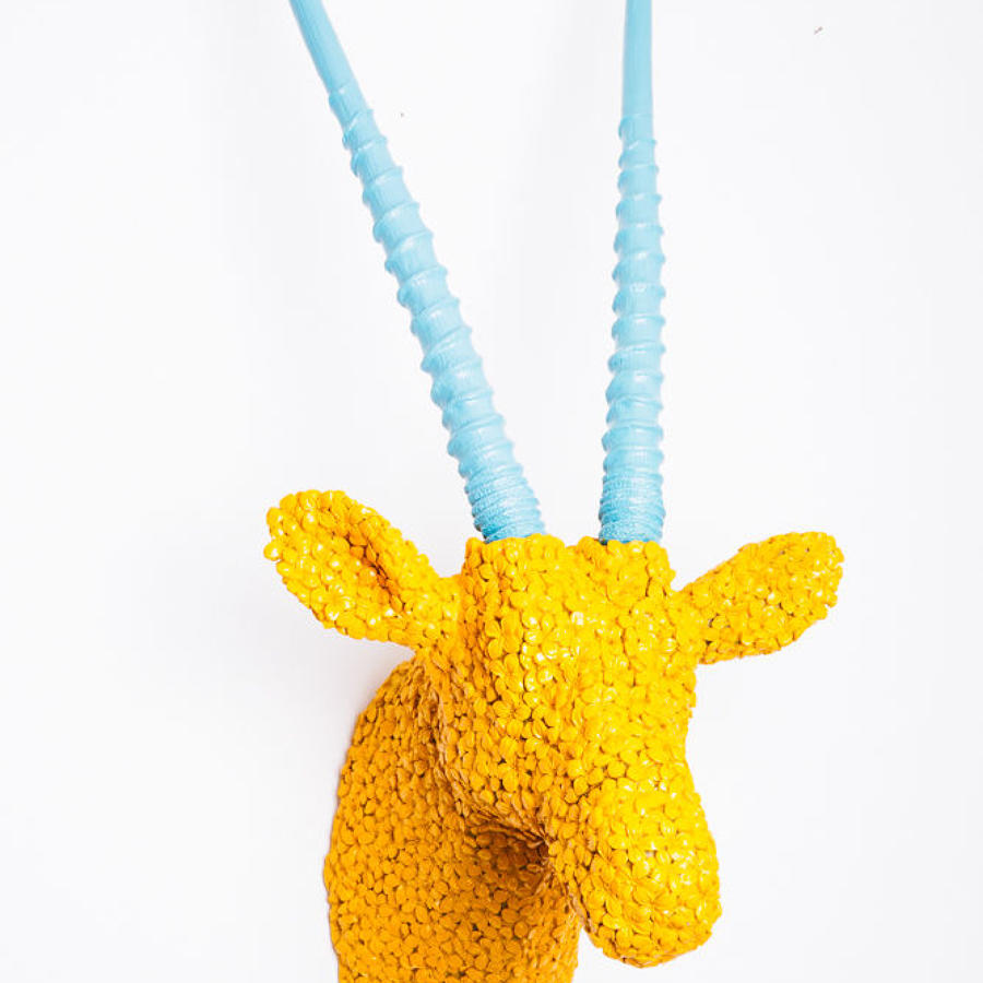 Yellow antelope trophy head with turquoise horns