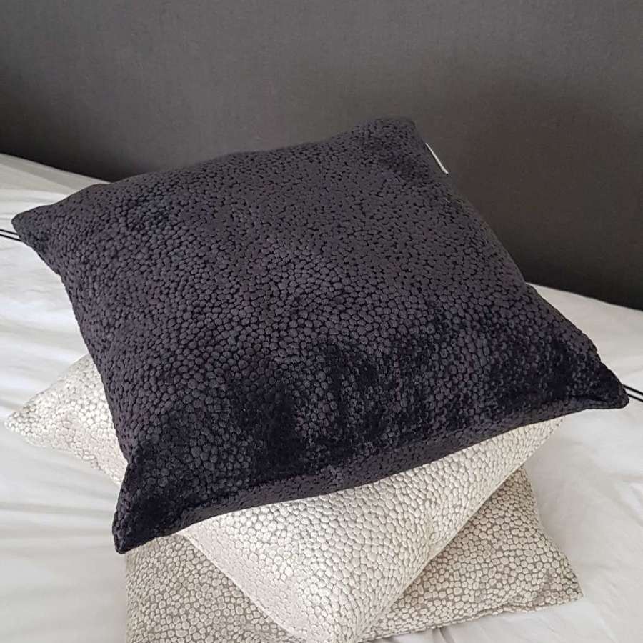 Textured black cushion with velvet dot design