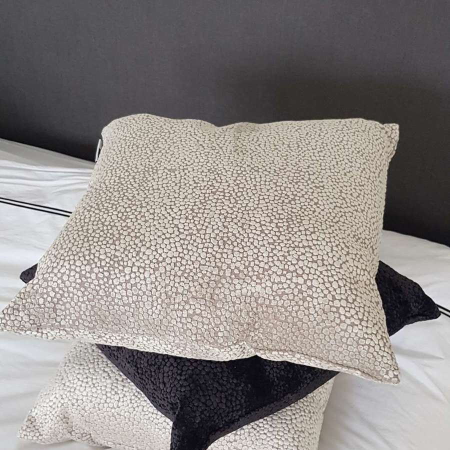 Textured taupe cushion with velvet dot design