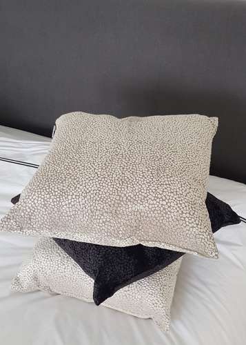Textured taupe cushion with velvet dot design