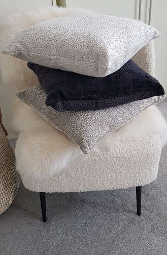Textured taupe cushion with velvet dot design