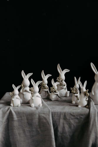 Small white ceramic Easter bunny with hands clasped